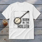 White t-shirt with a banjo graphic and text "BORN IN THE HOLLER".
