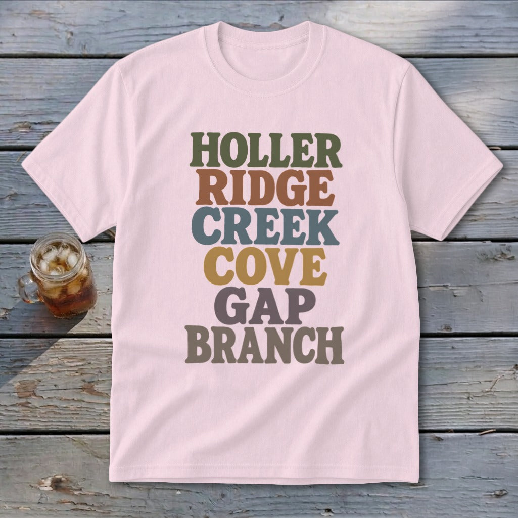 Light pink t-shirt featuring stacked multicolored text reading HOLLER RIDGE CREEK COVE GAP BRANCH.