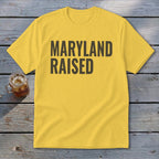 Yellow t-shirt with "MARYLAND RAISED" printed in dark gray text.