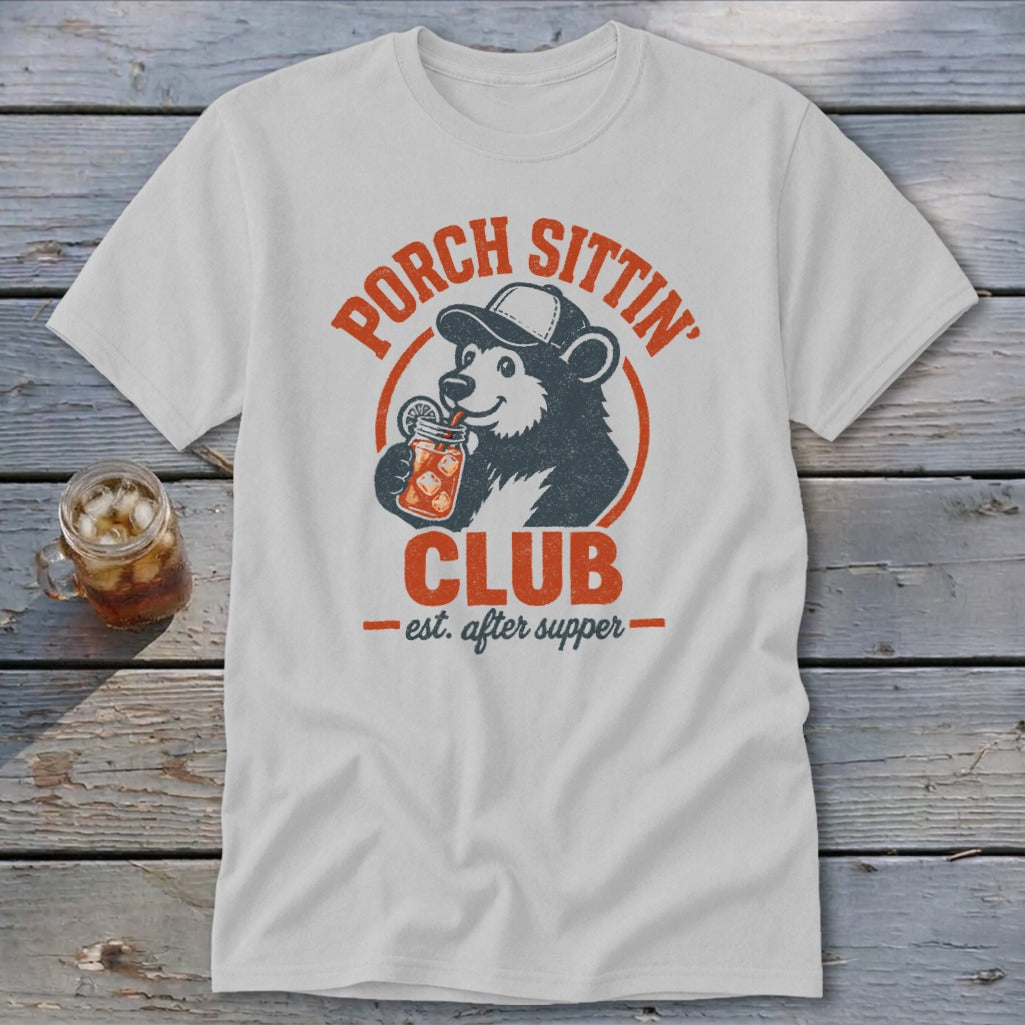White t-shirt with distressed graphic of bear in hat drinking from jar, "Porch Sittin' Club" text.