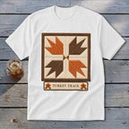 White t-shirt with quilted "Turkey Track" design in brown and orange.