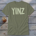 Olive green t-shirt with "YINZ" in pale green block letters.