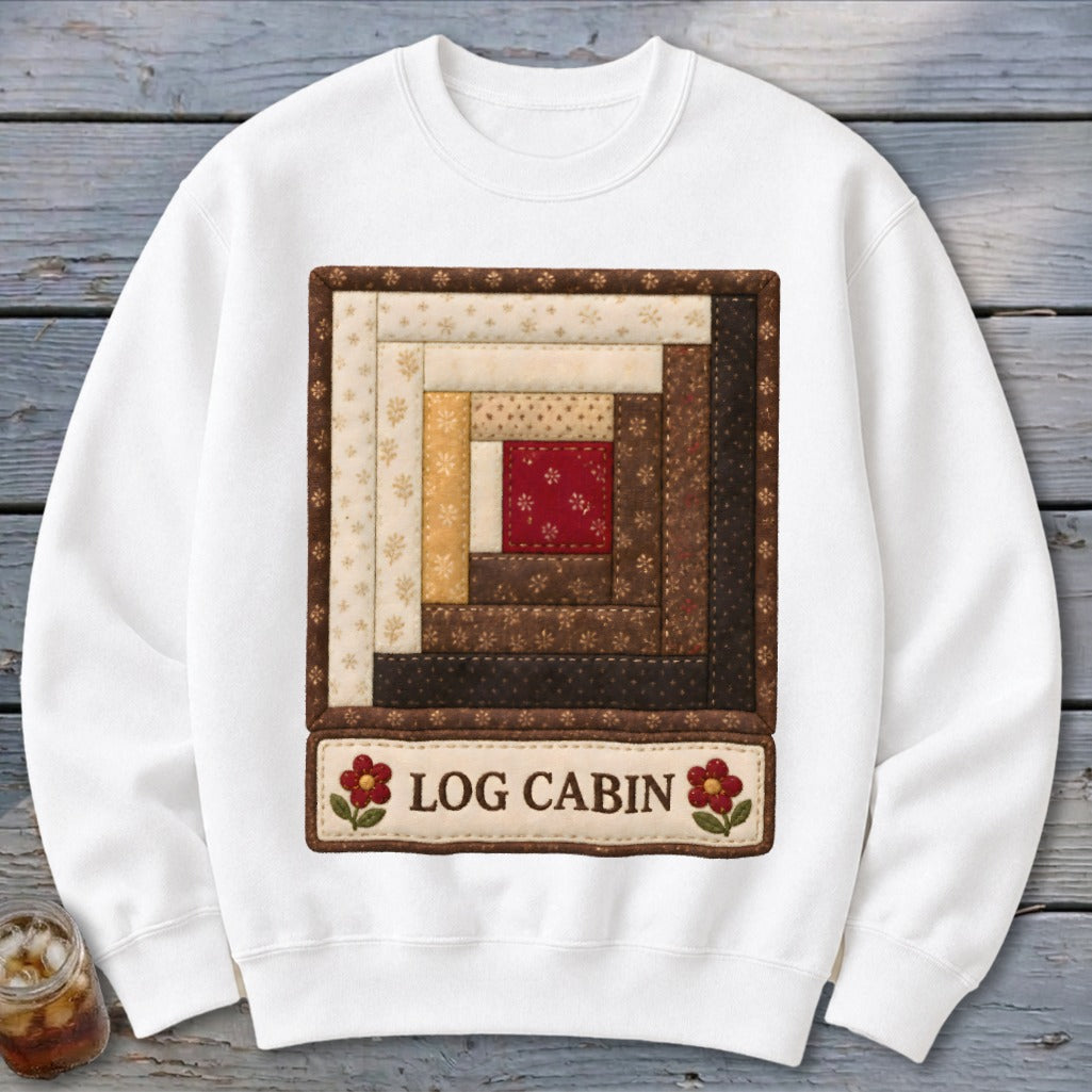 White sweatshirt with a square log cabin quilt pattern and "LOG CABIN" text.