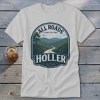 White t-shirt with "All Roads Lead to the Holler" graphic featuring a winding road through mountains.