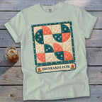 Light blue t-shirt with a quilt block graphic and "DRUNKARD'S PATH" text.
