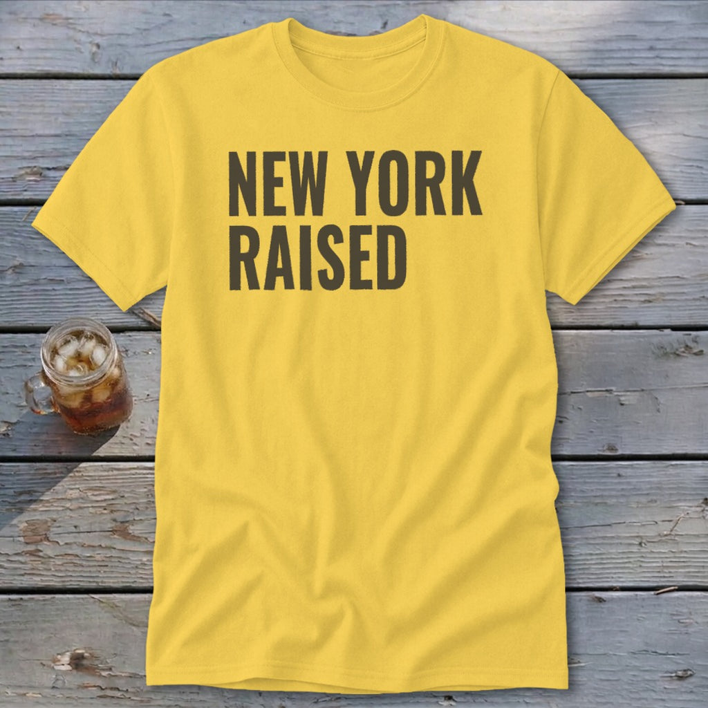 Yellow t-shirt with black text that reads "NEW YORK RAISED".