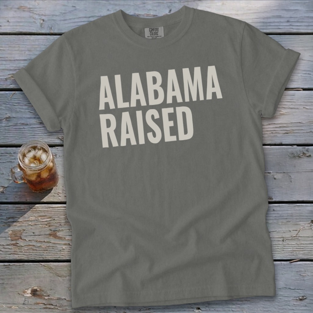 Gray t-shirt with "ALABAMA RAISED" printed in white text.