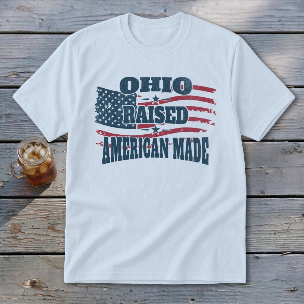 A white t-shirt featuring a distressed American flag and the text Ohio Raised American Made.