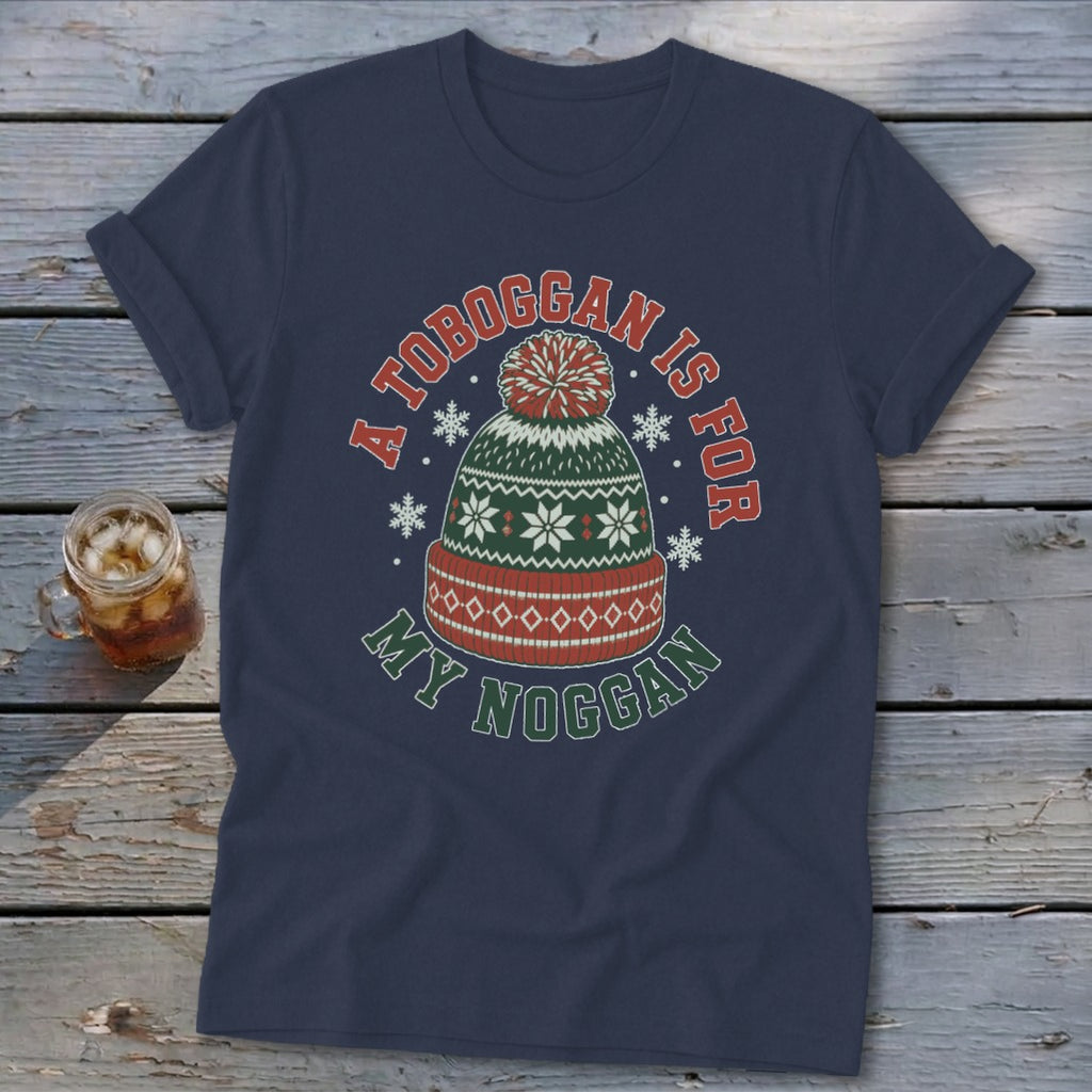 Navy blue t-shirt with a winter hat graphic and text reading "A toboggan is for my noggan."