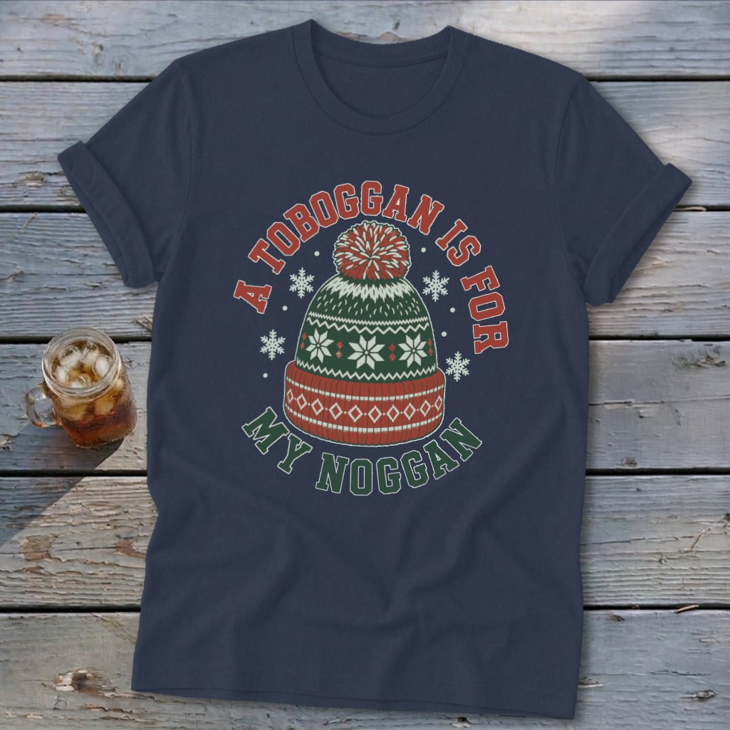 Navy blue t-shirt with a winter hat graphic and text reading "A toboggan is for my noggan."