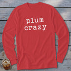 Red long sleeve shirt with white text that says "plum crazy"