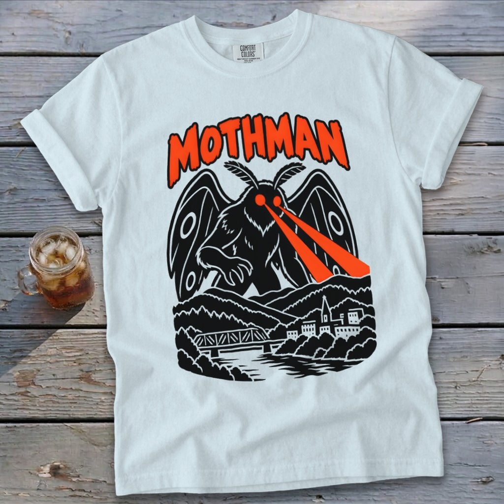 White t-shirt with a black Mothman graphic with red laser eyes over a town and bridge.