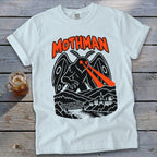 White t-shirt with a black Mothman graphic with red laser eyes over a town and bridge.