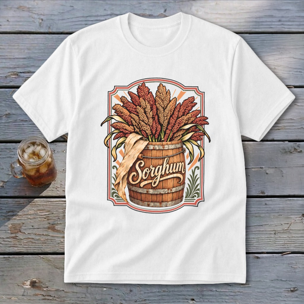 White t-shirt graphic with a wooden barrel overflowing with sorghum stalks, text reads "Sorghum."
