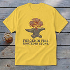 Yellow t-shirt with anvil, tree, and text "Forged in Fire Rooted in Stone".