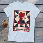 Light blue t-shirt with a "Sunbonnet Sue" quilt design featuring a girl holding flowers.