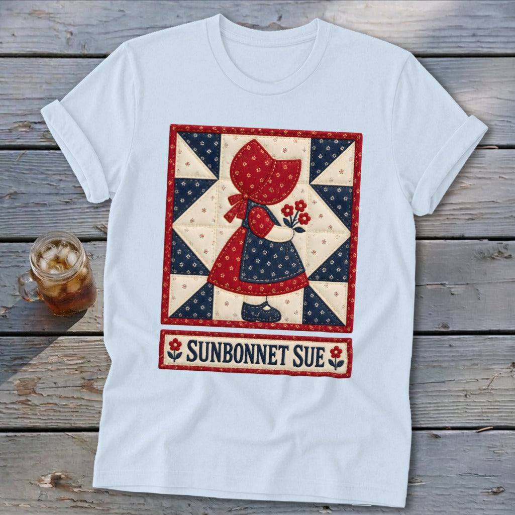 Light blue t-shirt with a "Sunbonnet Sue" quilt design featuring a girl holding flowers.