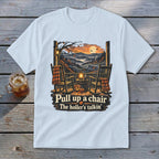 T-shirt with fall porch scene, rocking chairs, pumpkin, and text "Pull up a chair The holler's talkin'".