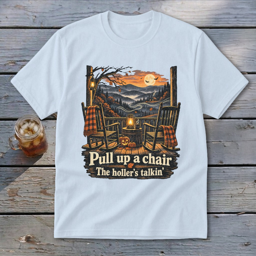 T-shirt with fall porch scene, rocking chairs, pumpkin, and text "Pull up a chair The holler's talkin'".