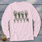 Light pink long-sleeve t-shirt featuring a green botanical illustration of four mason jars filled with wildflowers on a shelf.