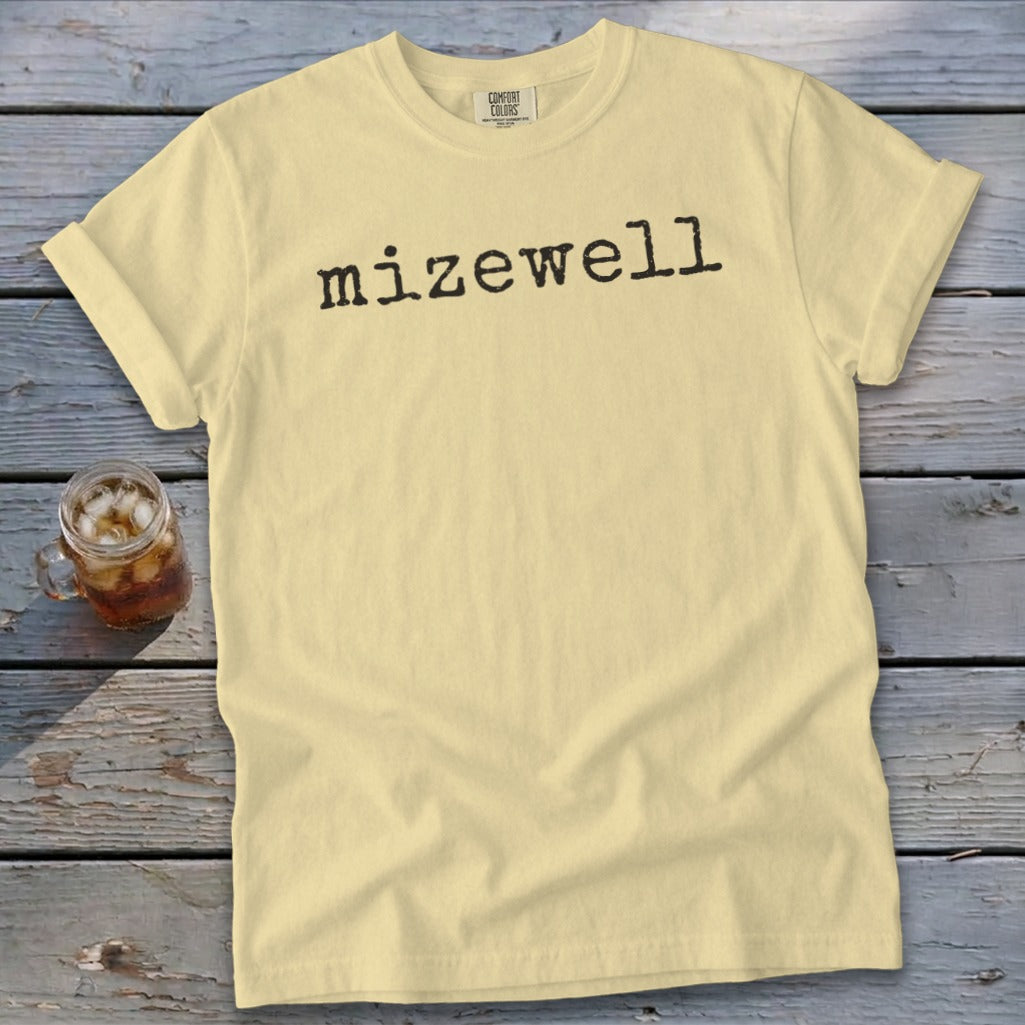 Pale yellow t-shirt with "mizewell" printed in black on the front.