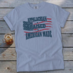Appalachian Raised American Made flag t-shirt on wooden surface.