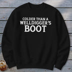 Black crewneck sweatshirt with white text reading "Colder than a welldigger's boot."