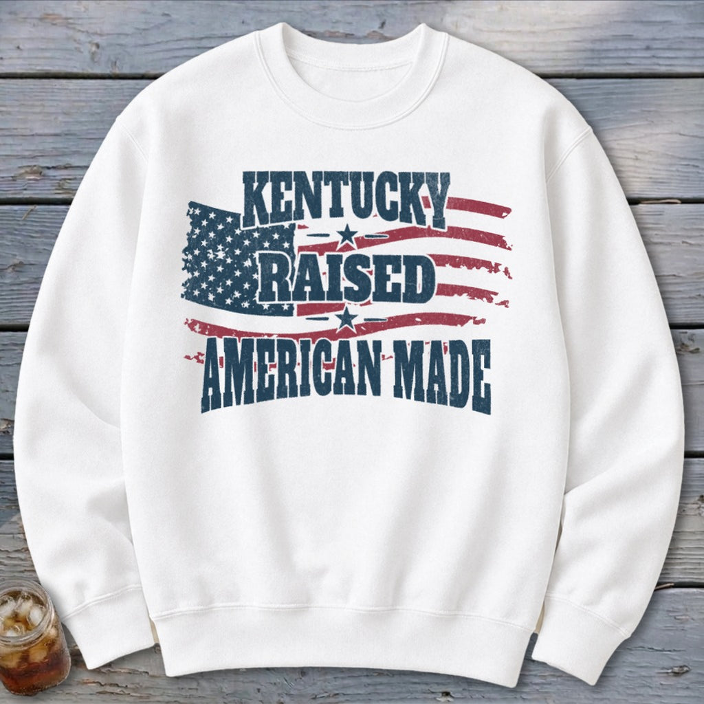 White sweatshirt with "Kentucky Raised American Made" text and distressed American flag graphic.