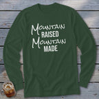 Green long-sleeve shirt with "Mountain Raised Mountain Made" text in white.