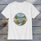 White v-neck t-shirt featuring "North Carolina" text within a circular landscape graphic.