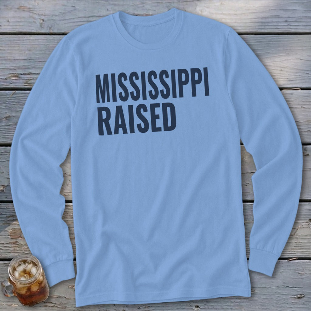Light blue long-sleeve shirt with black text "MISSISSIPPI RAISED"