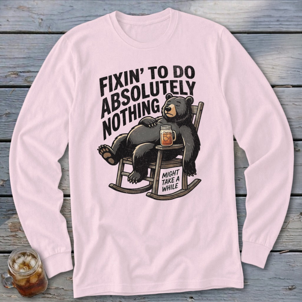 Light pink long-sleeve t-shirt with a graphic of a relaxed bear in a rocking chair holding a drink.