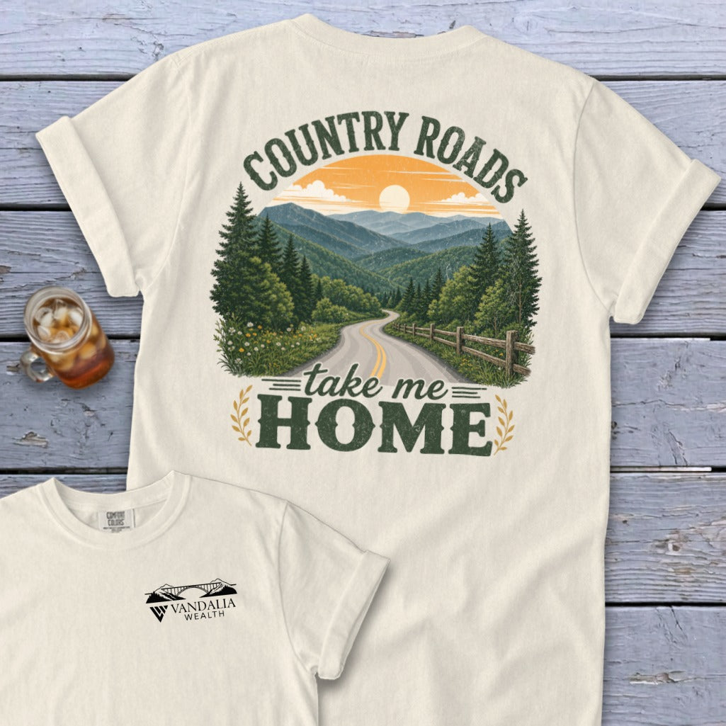 Cream t-shirt with "Country Roads Take Me Home" and mountain scene graphic.