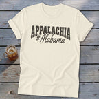 Cream t-shirt with "APPALACHIA #Alabama" text on a rustic wooden background.
