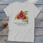 White t-shirt with a red trillium flower graphic and text "MOUNTAIN SPRING AWAKENING".