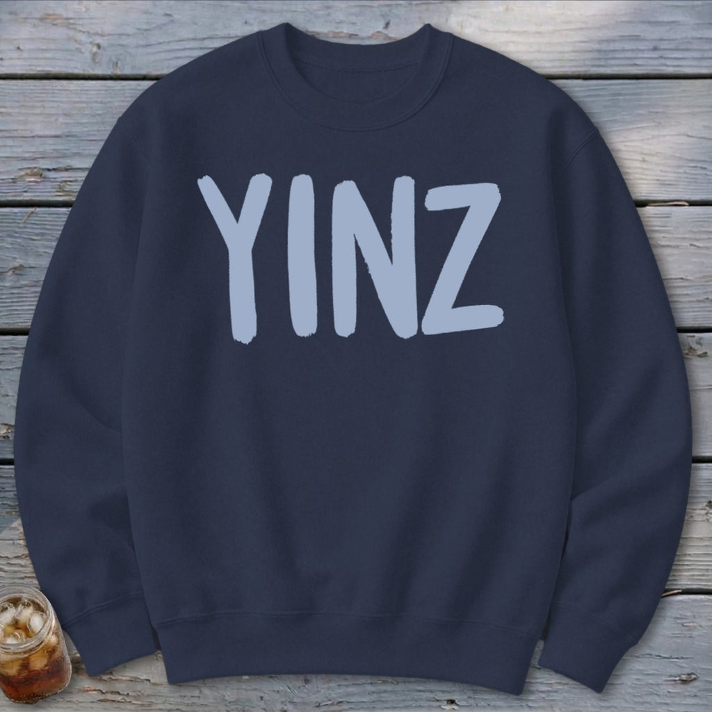 Navy sweatshirt with light blue "YINZ" text centered on the front.