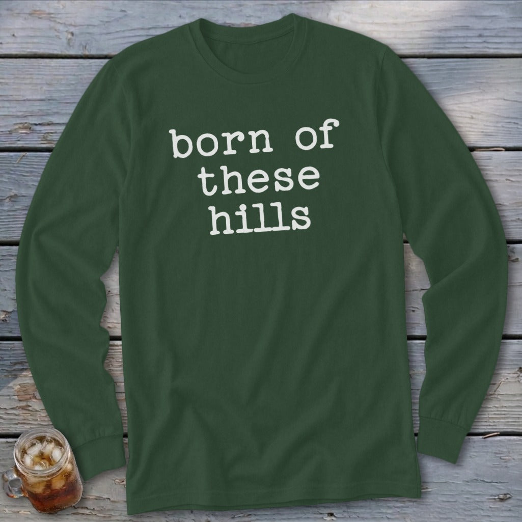 Long sleeve dark green shirt with white text that reads "born of these hills."
