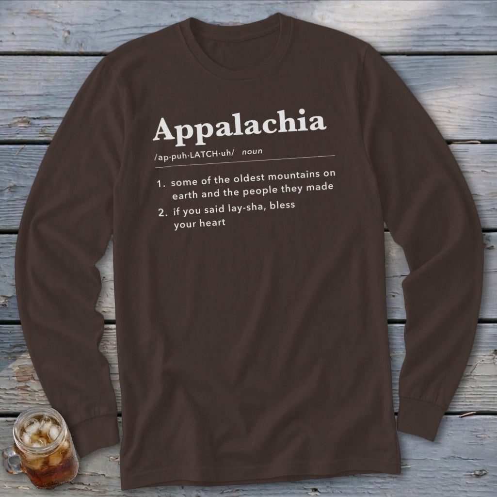 Brown long-sleeve t-shirt featuring dictionary-style text defining Appalachia, laid flat on a wooden surface.