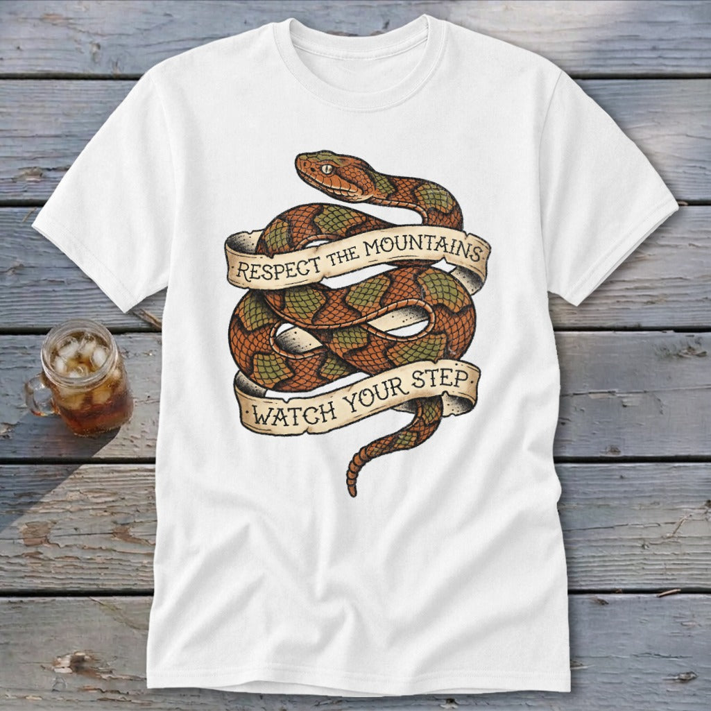 White t-shirt with coiled snake graphic and banner text: "RESPECT THE MOUNTAINS. WATCH YOUR STEP."