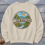 Cream sweatshirt with circular West Virginia graphic featuring mountains, river, deer, and sun.