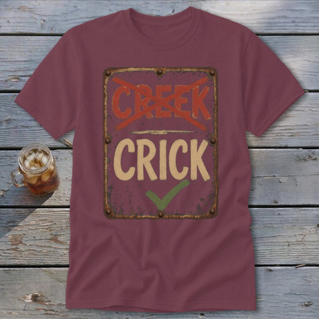 Maroon t-shirt with distressed sign reading "Creek" crossed out and "Crick" with checkmark.