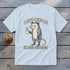 Light blue t-shirt with a grumpy possum holding coffee, text "DON'T MIND ME I'M JUST SULLED UP".