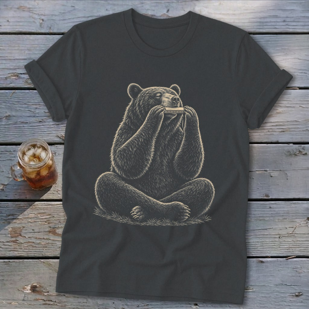 Bear sitting cross-legged playing a harmonica on a dark t-shirt.