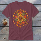Maroon t-shirt with a circular autumn leaf and acorn design centered on the chest.