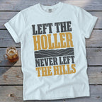 White t-shirt with text "Left the Holler Never Left the Hills" and mountain graphic.