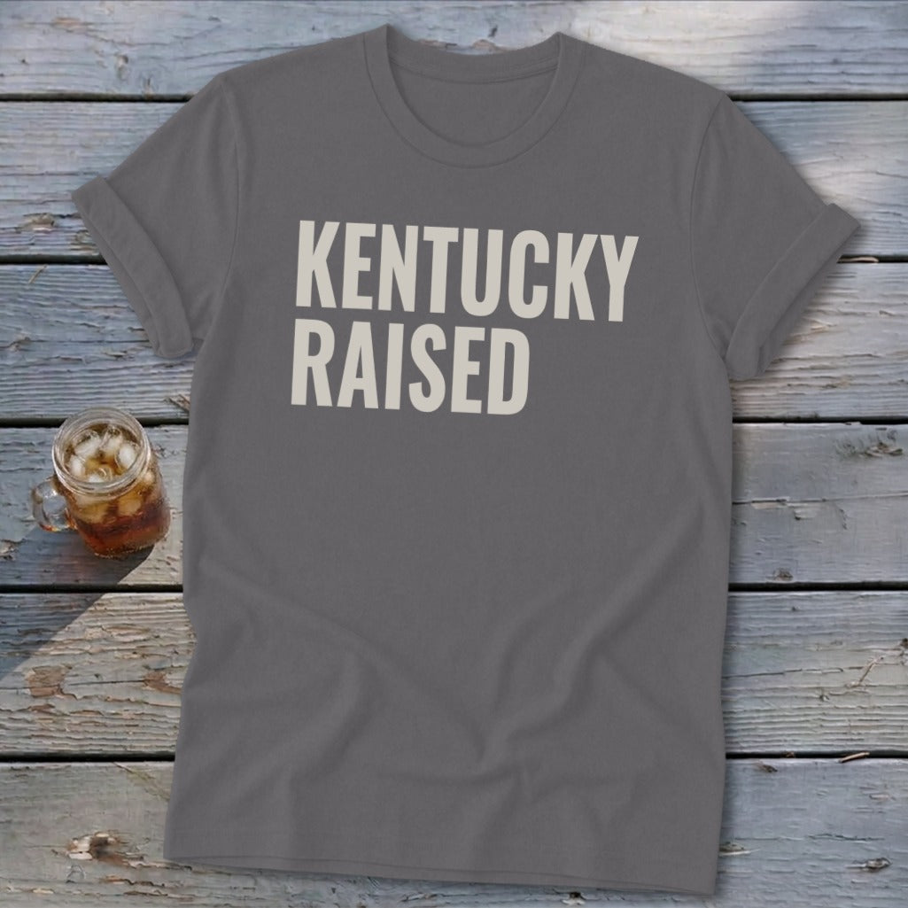 Gray t-shirt with "KENTUCKY RAISED" text in a casual, bold font.