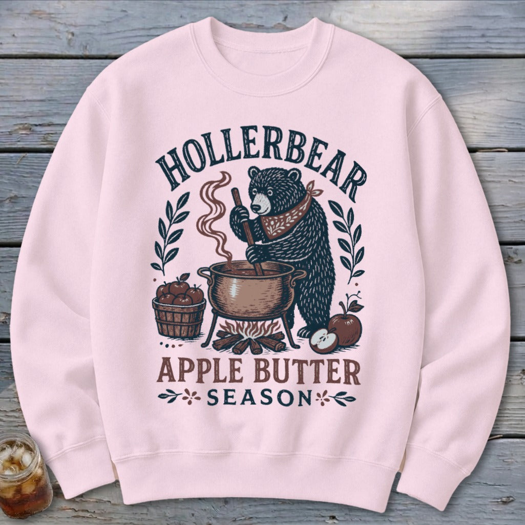 Pink sweatshirt with a bear making apple butter, text reads "Hollerbear Apple Butter Season".