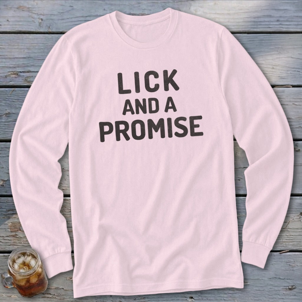 Light pink long-sleeve t-shirt with black text: "LICK AND A PROMISE".