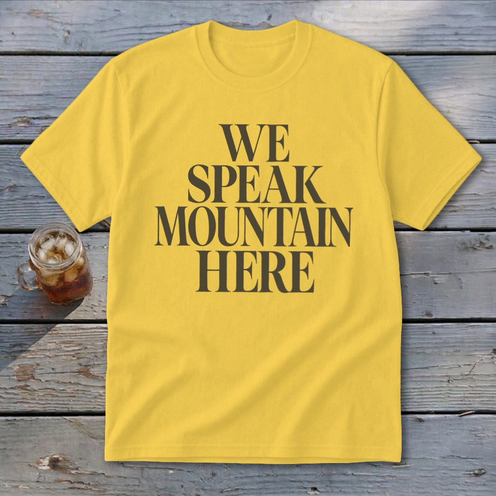 Yellow t-shirt with "WE SPEAK MOUNTAIN HERE" text and a glass of iced tea.