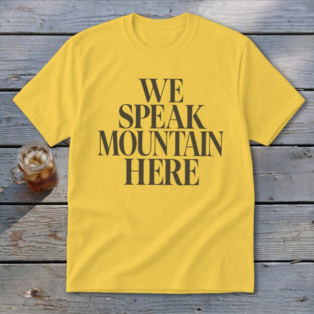 Yellow t-shirt with "WE SPEAK MOUNTAIN HERE" text and a glass of iced tea.